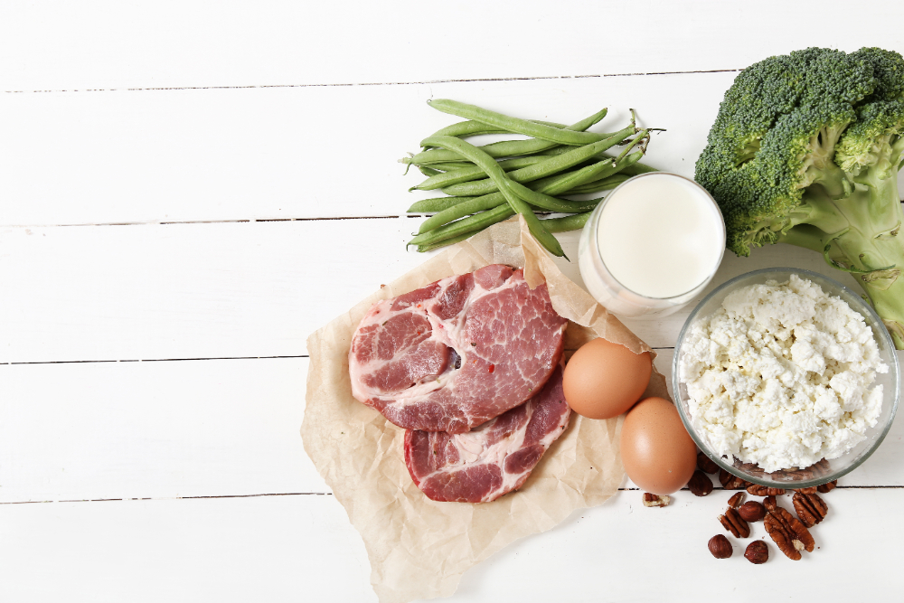Healthy food rich in proteins on a white wooden table.