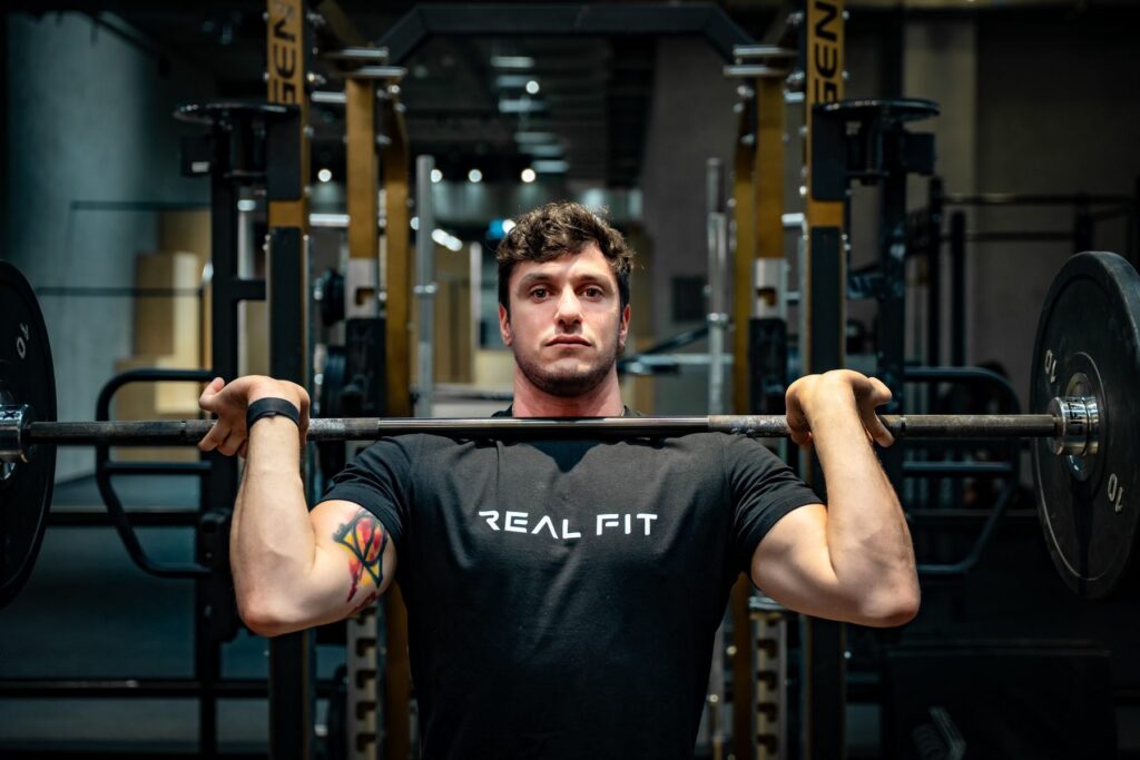 Marcello holding a barbell on his shoulders